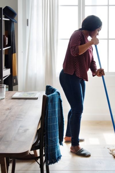 Black woman cleaning room
