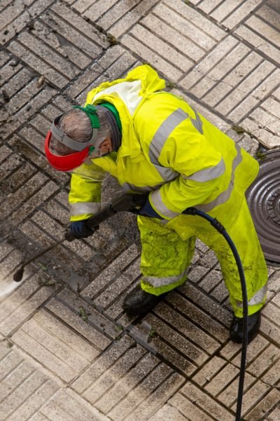 Worker cleaning a street sidewalk